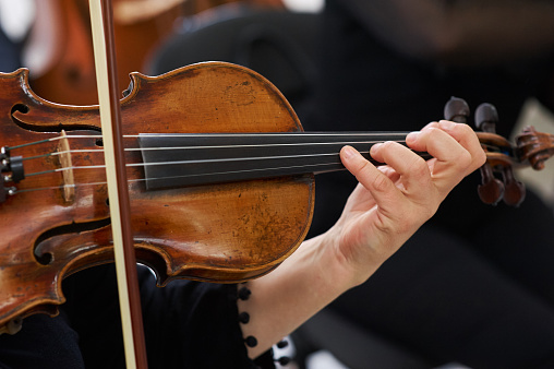 Women Violinist Playing Classical Violin Music in Musical Performance